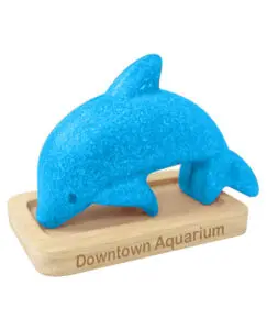 A blue dolphin is on the wooden stand.
