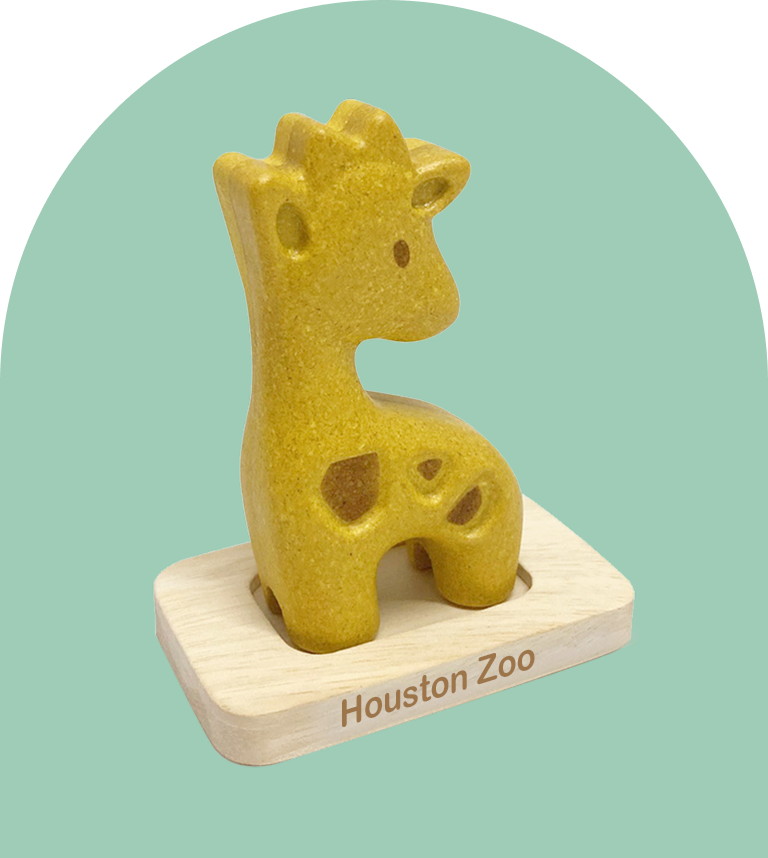 A wooden giraffe toy sitting on top of a wood block.
