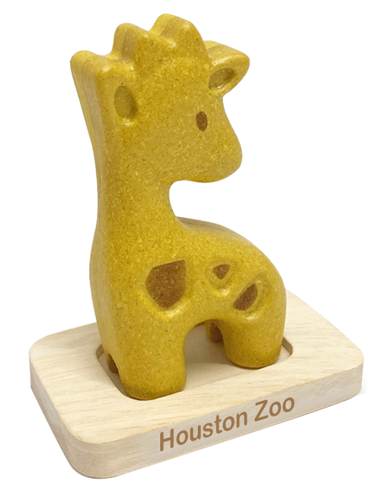 Houston Zoo Giraffe A wooden giraffe toy sitting on top of a table.